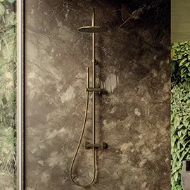 Wall-mounted shower fittings against textured stone
